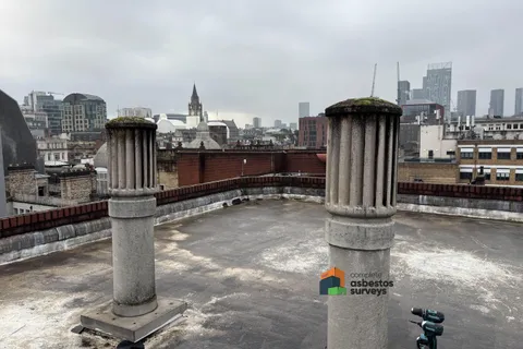 Asbestos cement roof cowls on commercial roof