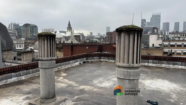 Asbestos cement roof cowls on commercial roof