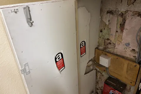 Asbestos insulating board containing chrysotile and amosite identified within an electrical cupboard during the management survey.