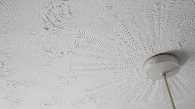 Decorative textured coating, commonly known as Artex, applied to a ceiling around a light fitting. Some older textured coatings may contain small amounts of asbestos and should be tested before drilling, sanding or removal.