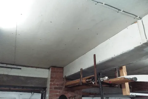 Asbestos insulating board ceiling in garage