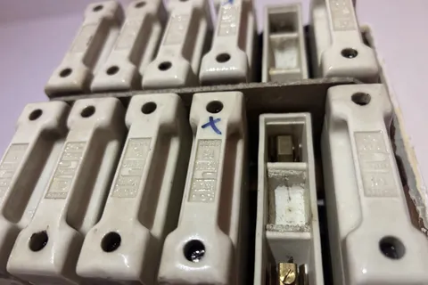 Asbestos fuse guards from domestic property