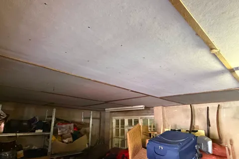 Asbestos insulating board ceiling identified in the garage during pre-purchase asbestos testing at a York home, with licensed removal or suitable encapsulation recommended before occupation.