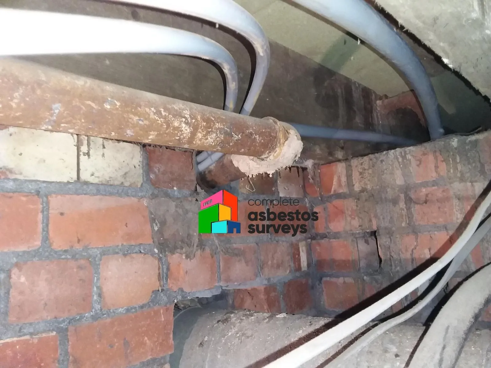 Asbestos insulation to pipe work under floor in older building