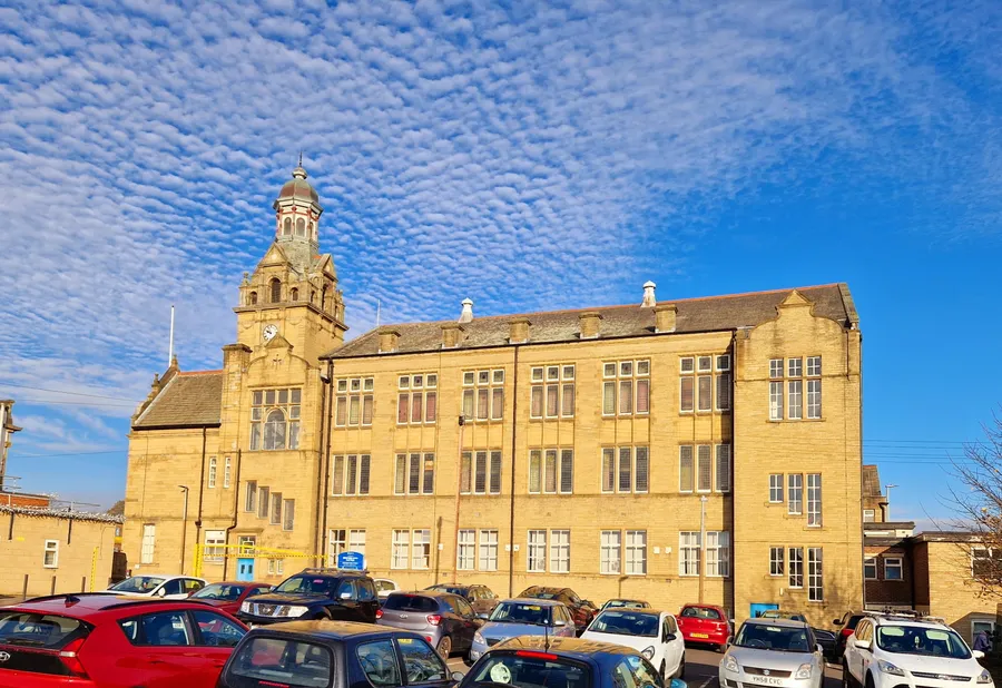 A large historic stone building in Cleckheaton, West Yorkshire, representing the types of older commercial properties that may require an asbestos survey.