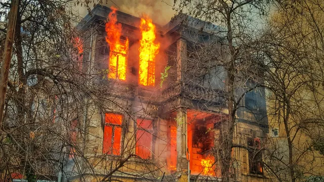 Building on fire containing asbestos