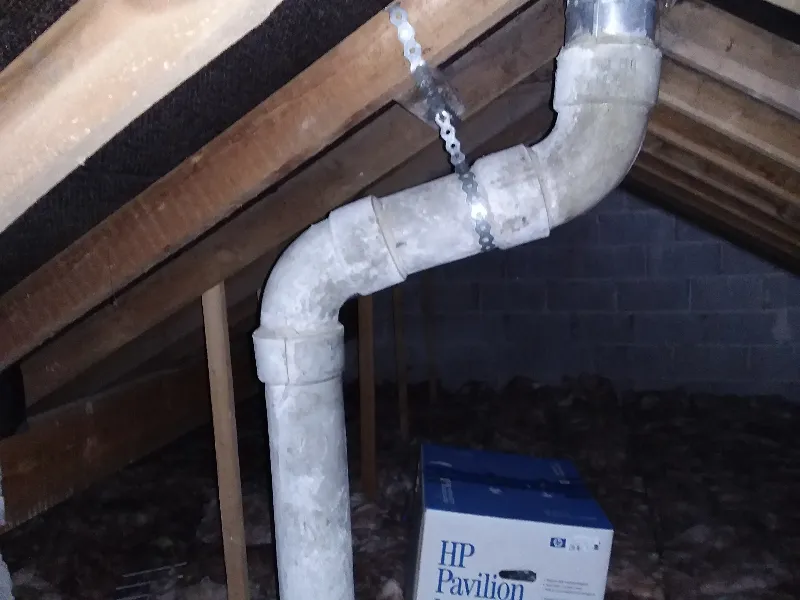 Asbestos cement flue pipe in loft