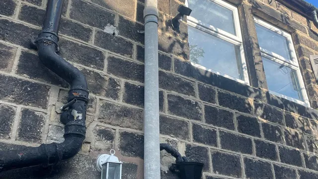 Asbestos flue pipe on outside of domestic property