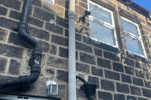 Asbestos flue pipe on outside of domestic property