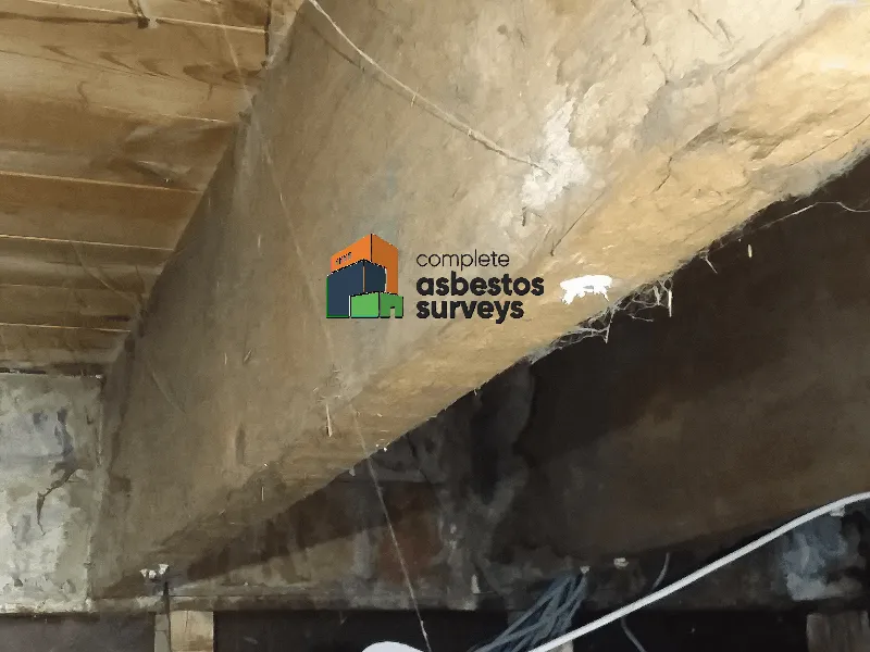 Debris From Old Asbestos Insulating Board Ceiling