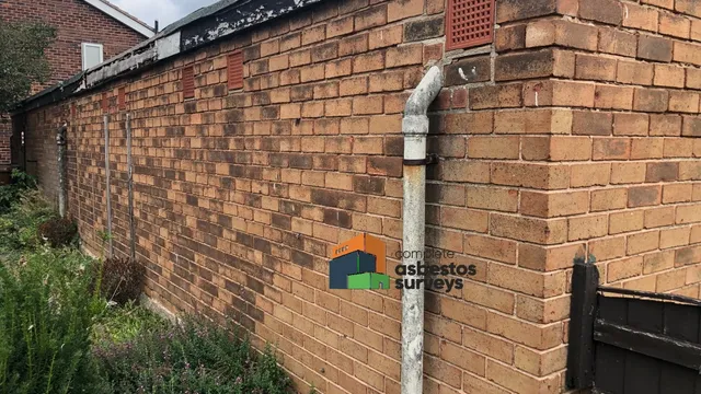 Asbestos Cement Downpipe to Rear of Garage