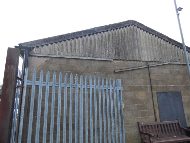 Asbestos cement wall and roof sheets on gable end on industrial unit