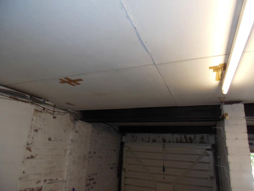 Asbestos cement ceiling panels within domestic property