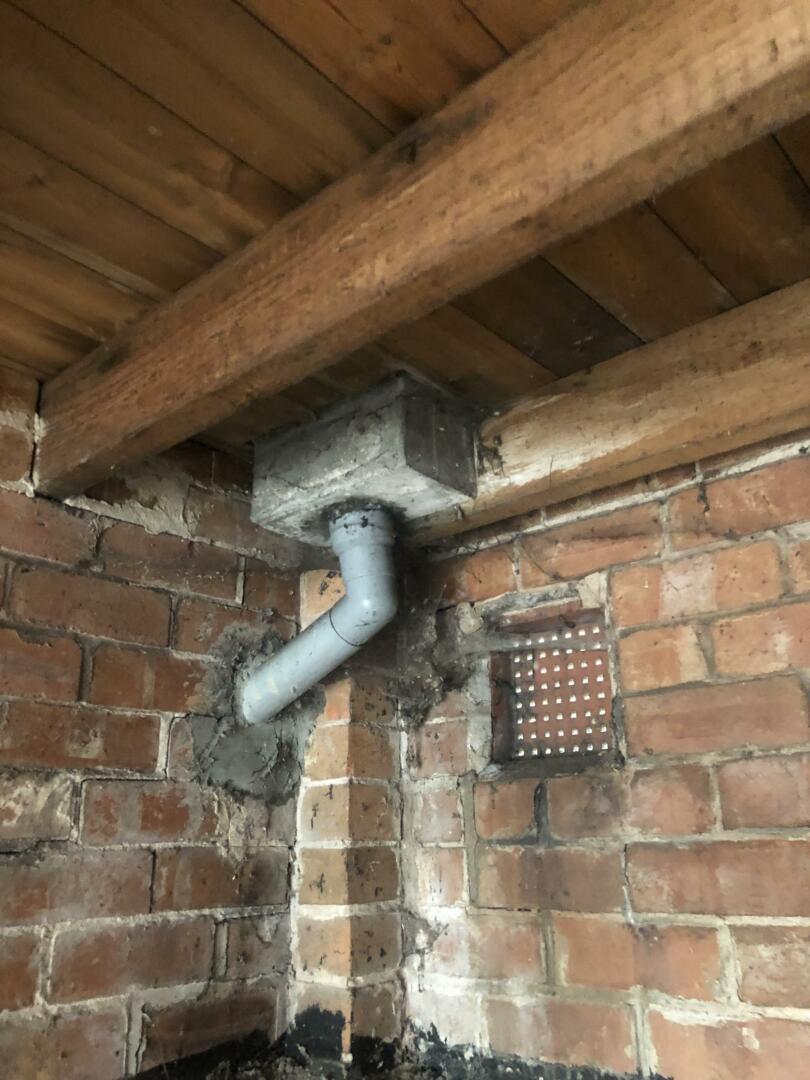 Asbestos cement rainwater hopper within external garage of property