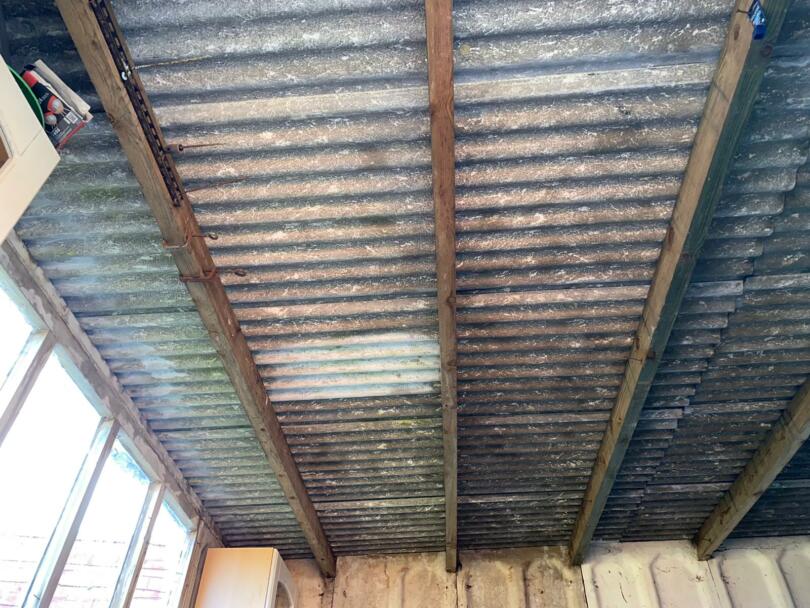 Asbestos cement roof sheets on domestic shed