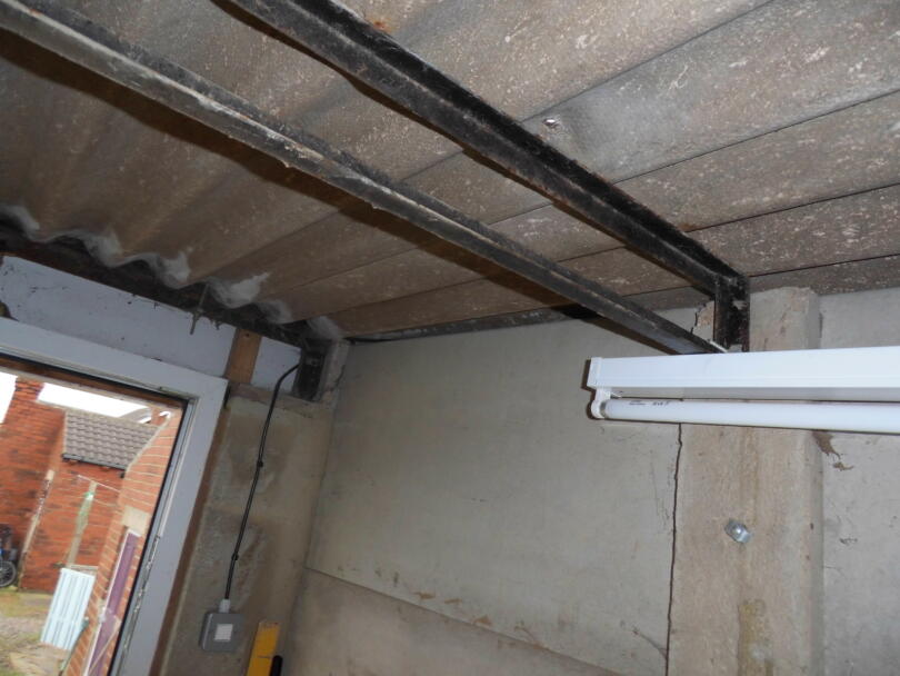 Asbestos cement garage roof attached to metal frame