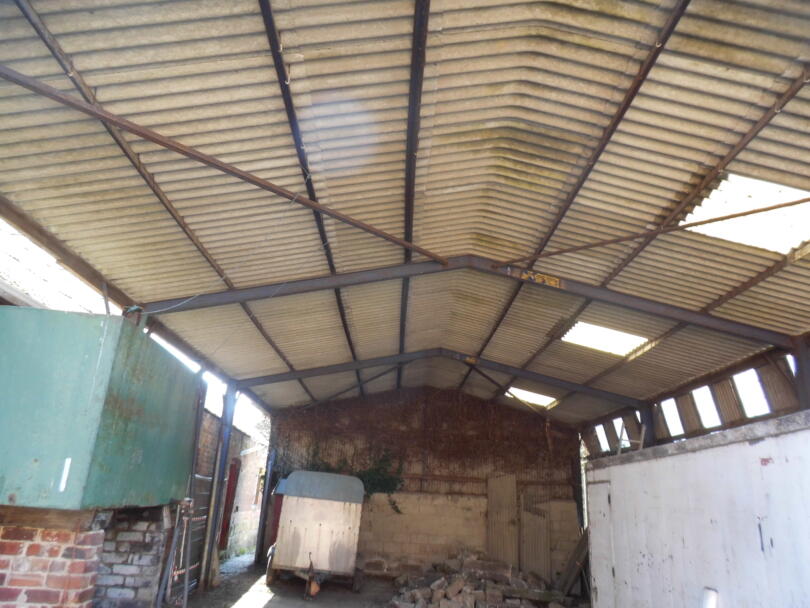 Asbestos corrugated cement sheets on barn roof