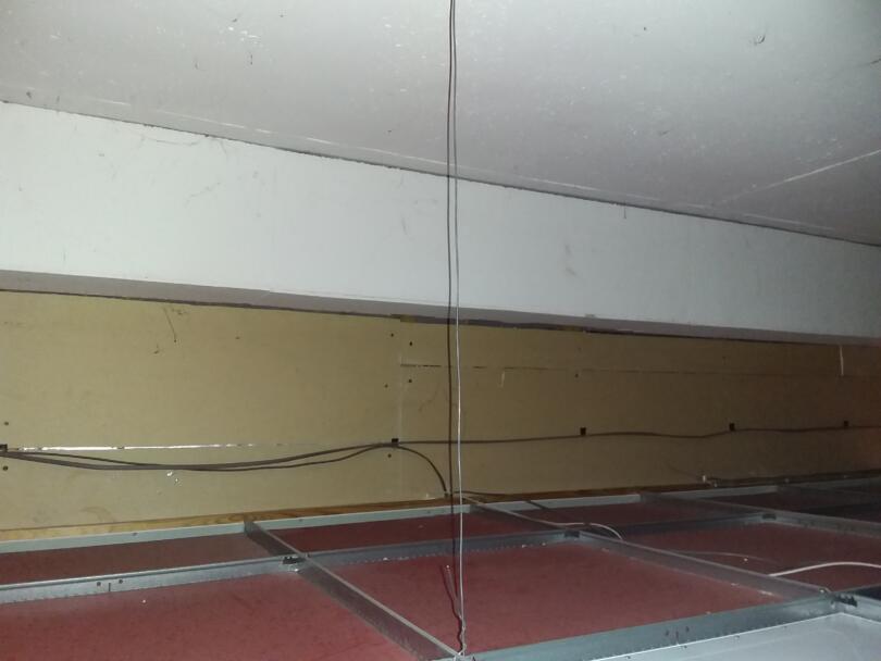 Asbestos insulating board bulkhead in ceiling void of commercial unit