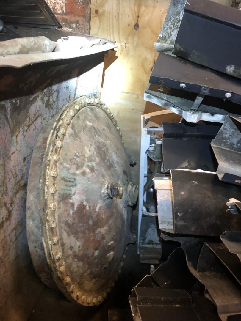 Asbestos insulation debris left on old cylinder lid within scrap yard pile