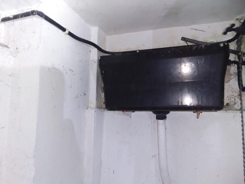 Asbestos composite toilet cistern in office toilets