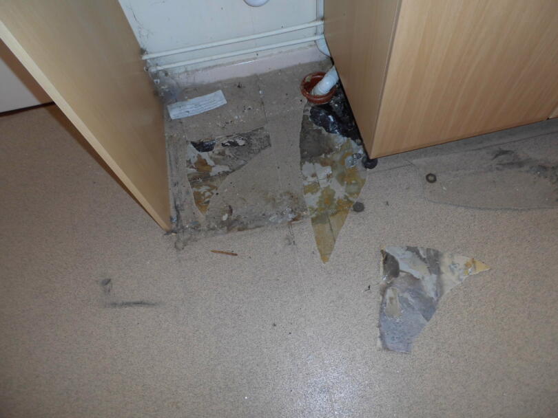 Asbestos vinyl floor tiles hidden under lino and kitchen cabinets