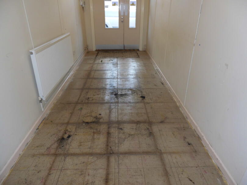 Asbestos vinyl floor tiles in hallway in good condition prior to removal