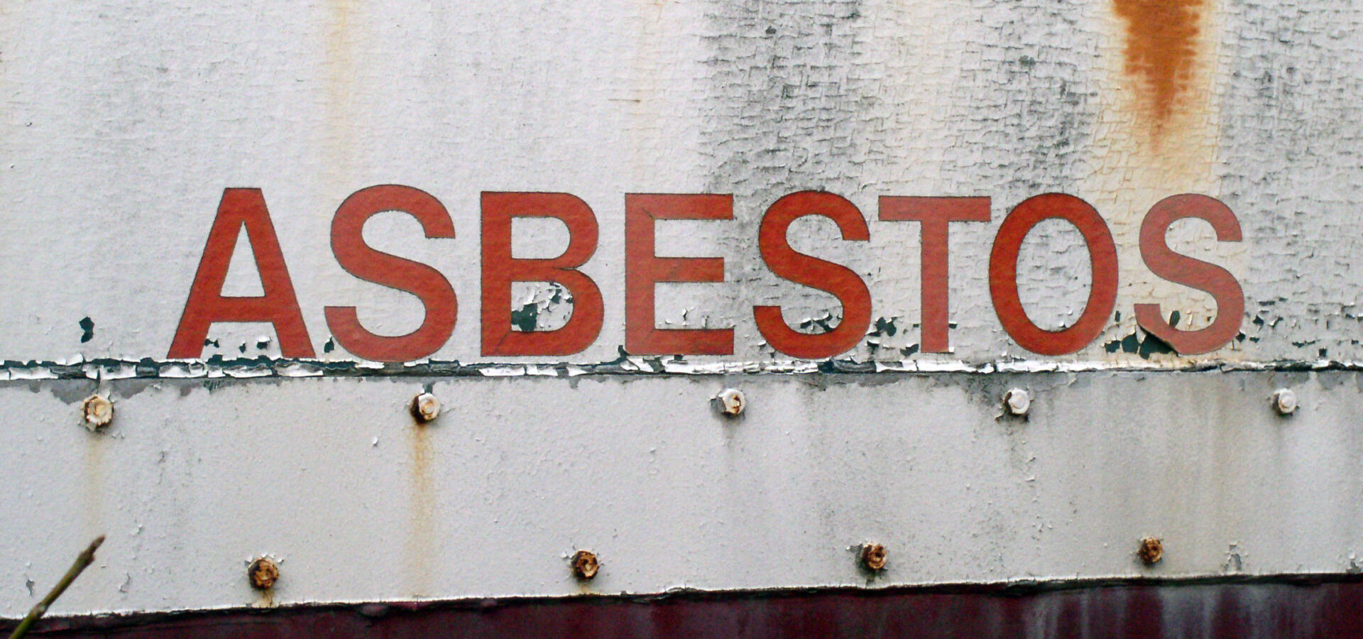 Asbestos warning sign on metal sheets