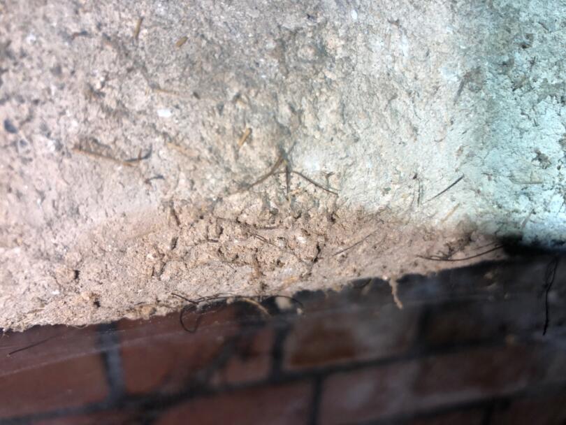 Close up of hand applied asbestos insulation to heating pipes