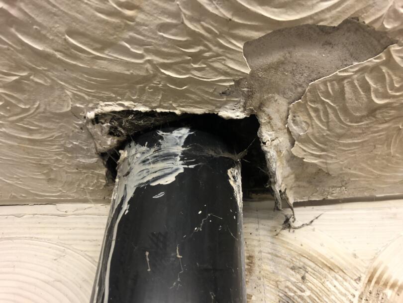 Damaged artex ceiling from where flue pipe was installed