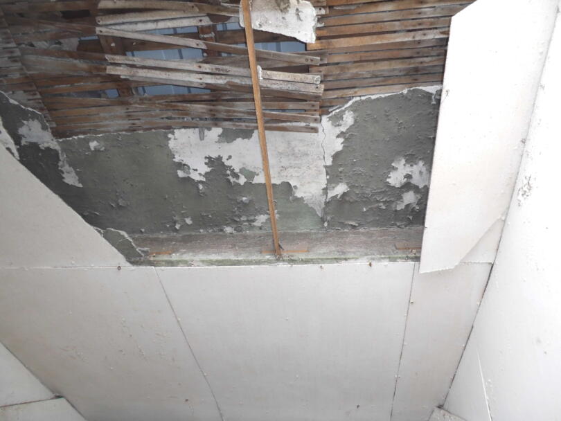 Asbestos insulating board over lath and plaster ceiling