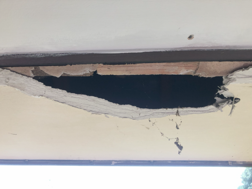 Damaged asbestos insulating board soffits