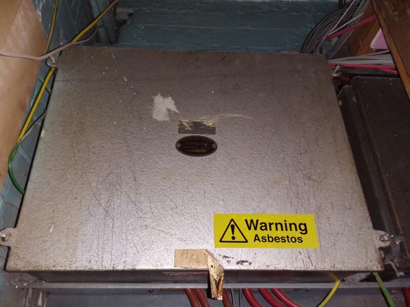 Warning asbestos sticker on electrical fuse boards
