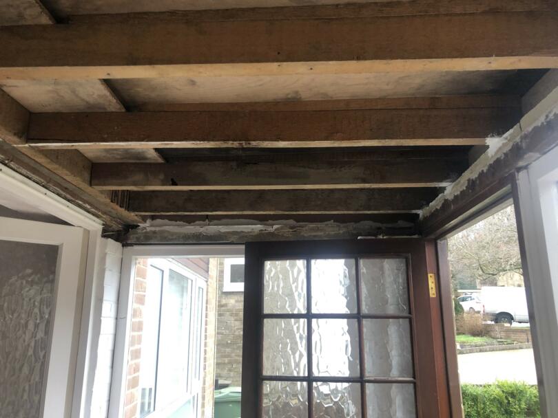 Encapsulated edge of cement ceiling panels where asbestos is trapped
