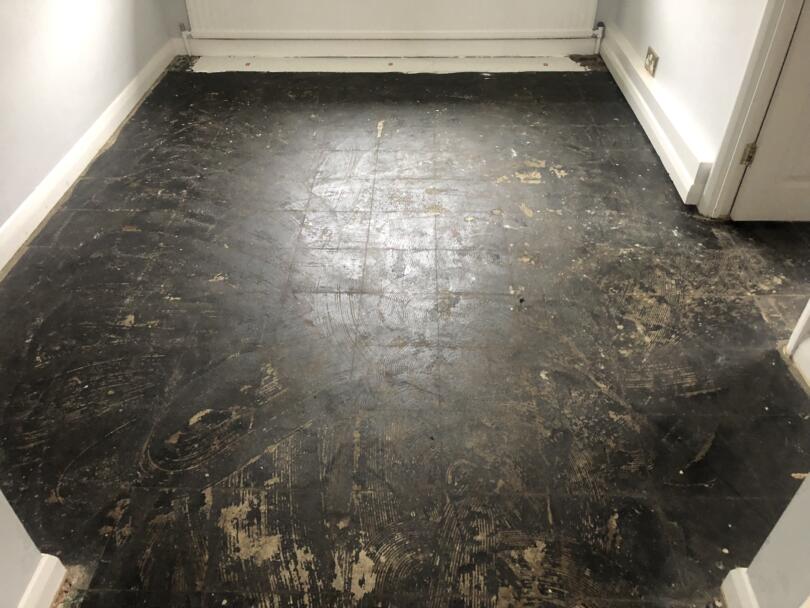Asbestos containing floor tile adhesive following removal of vinyl tiles