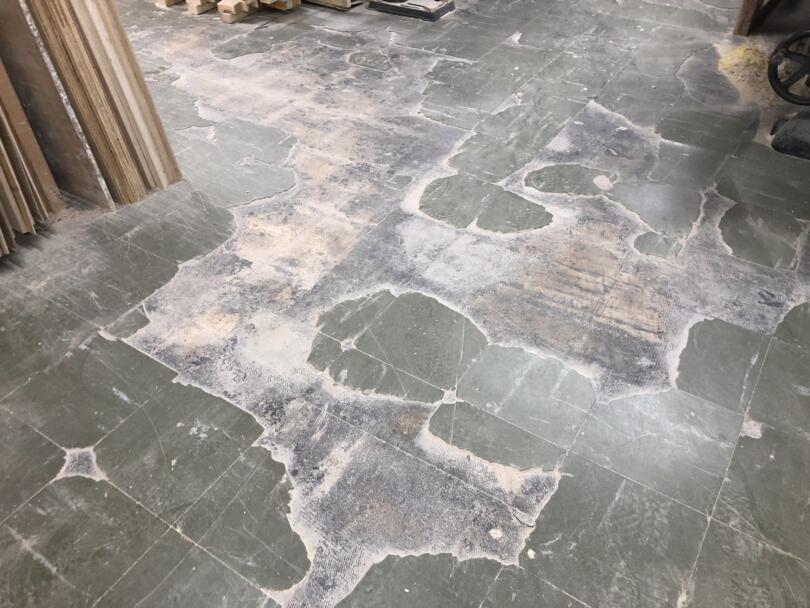 Damaged and loose asbestos vinyl floor tiles