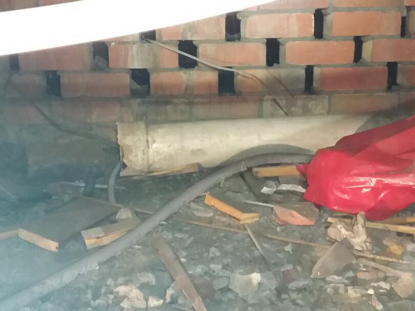 Loose asbestos cement flue pipe under floor of church