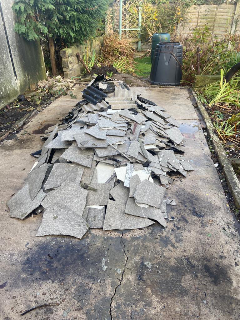 Pile of broken up asbestos cement sheets from poor garage removal by homeowner