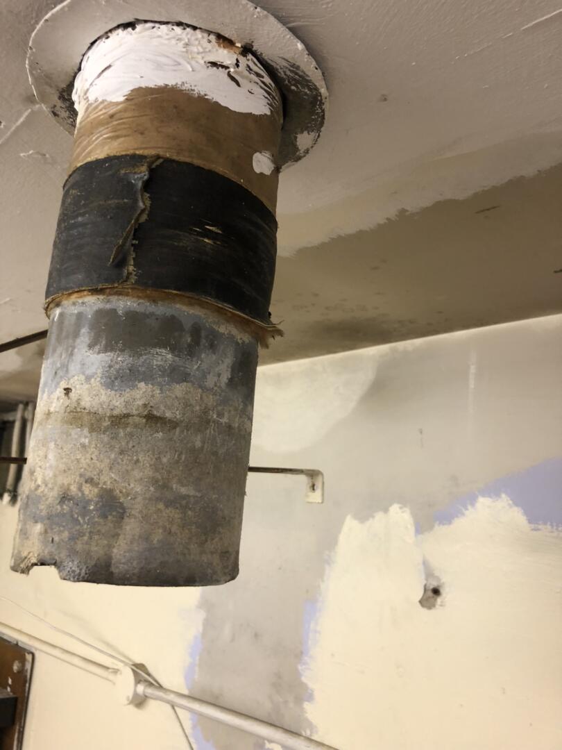 Asbestos cement flue pipe redundant from old boiler room