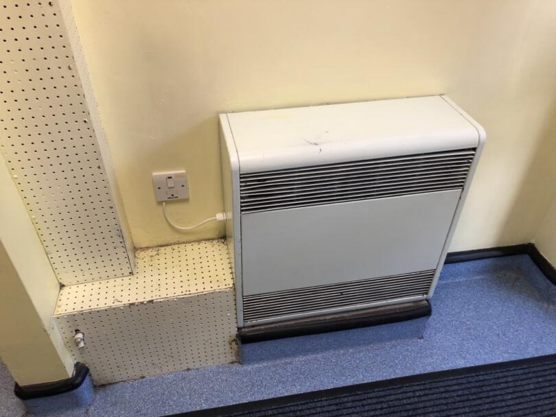 Small storage heater containing asbestos within school