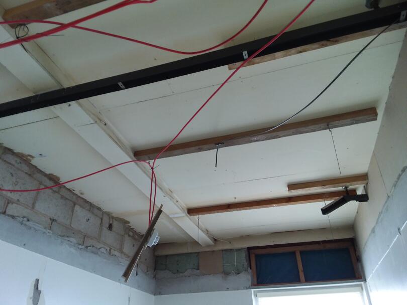 Unsealed asbestos insulating board ceiling found above false ceiling