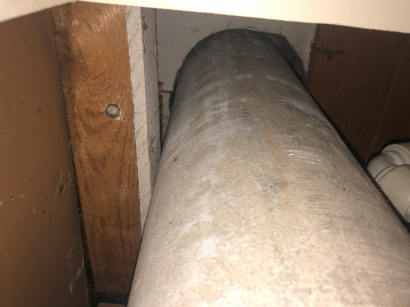 Asbestos cement flue pipe and asbestos insulating board lining