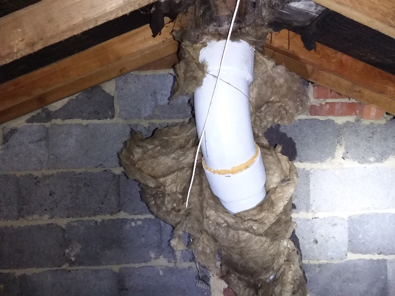 Asbestos cement flue pipe bend in loft
