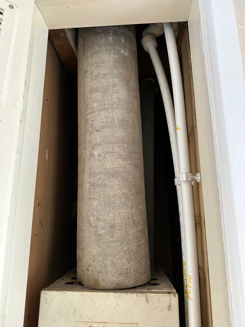 Asbestos cement flue pipe in boiler cupboard