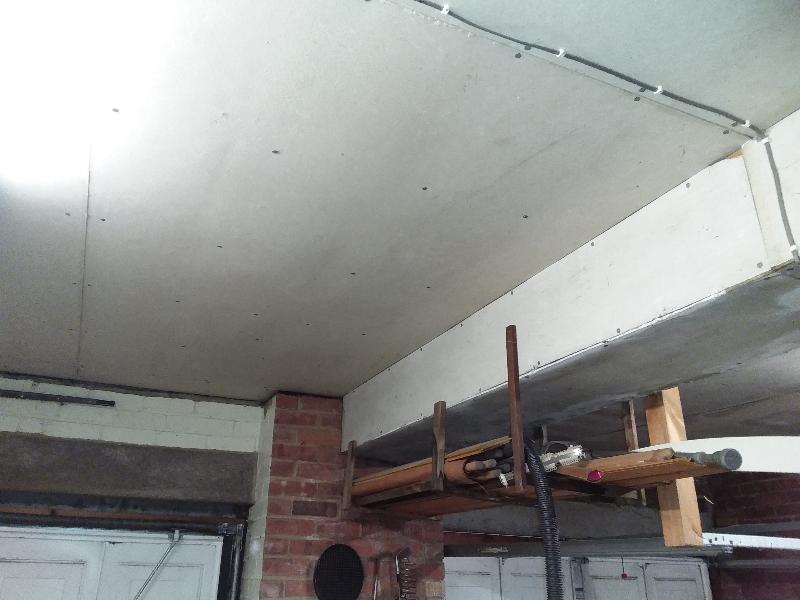 Asbestos insulating board ceiling and boxing within garage of domestic house