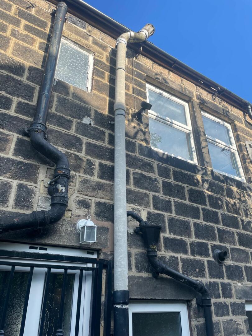 Asbestos flue pipe on outside of domestic property