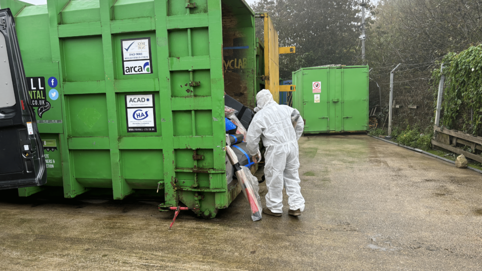 Loading asbestos waste into skip